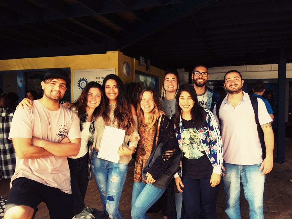 grupo de amigos sonrientes mirando a cámara en una escuela de Australia